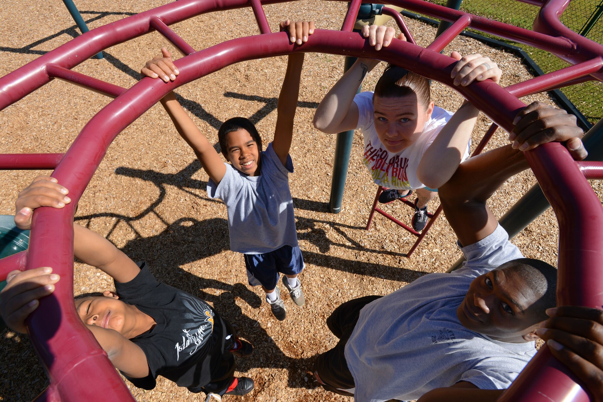 U.S. Air Force Senior Airman Taiwan Jackson, 20th Force Support Squadron fitness specialist, his wife Joni Jackson, and sons Jayden and Kyan, suspend from playground bars at Shaw Air Force Base, S.C., April 13, 2013. The Jackson family participated in the Health and Wellness Center program, ?New Year New You,? from Jan. 21 to March 17, 2013. (U.S. Air Force photo by Senior Airman Tabatha Zarrella/Released)
