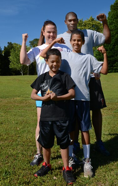 U.S. Air Force Senior Airman Taiwan Jackson, 20th Force Support Squadron fitness specialist, his wife Joni Jackson, and sons Jayden and Kyan, flex their muscles at Shaw Air Force Base, S.C., April 13, 2013. The Jackson family participated in the Health and Wellness Center program, ?New Year New You,? from Jan. 21 to March 17, 2013. (U.S. Air Force photo by Senior Airman Tabatha Zarrella/Released)