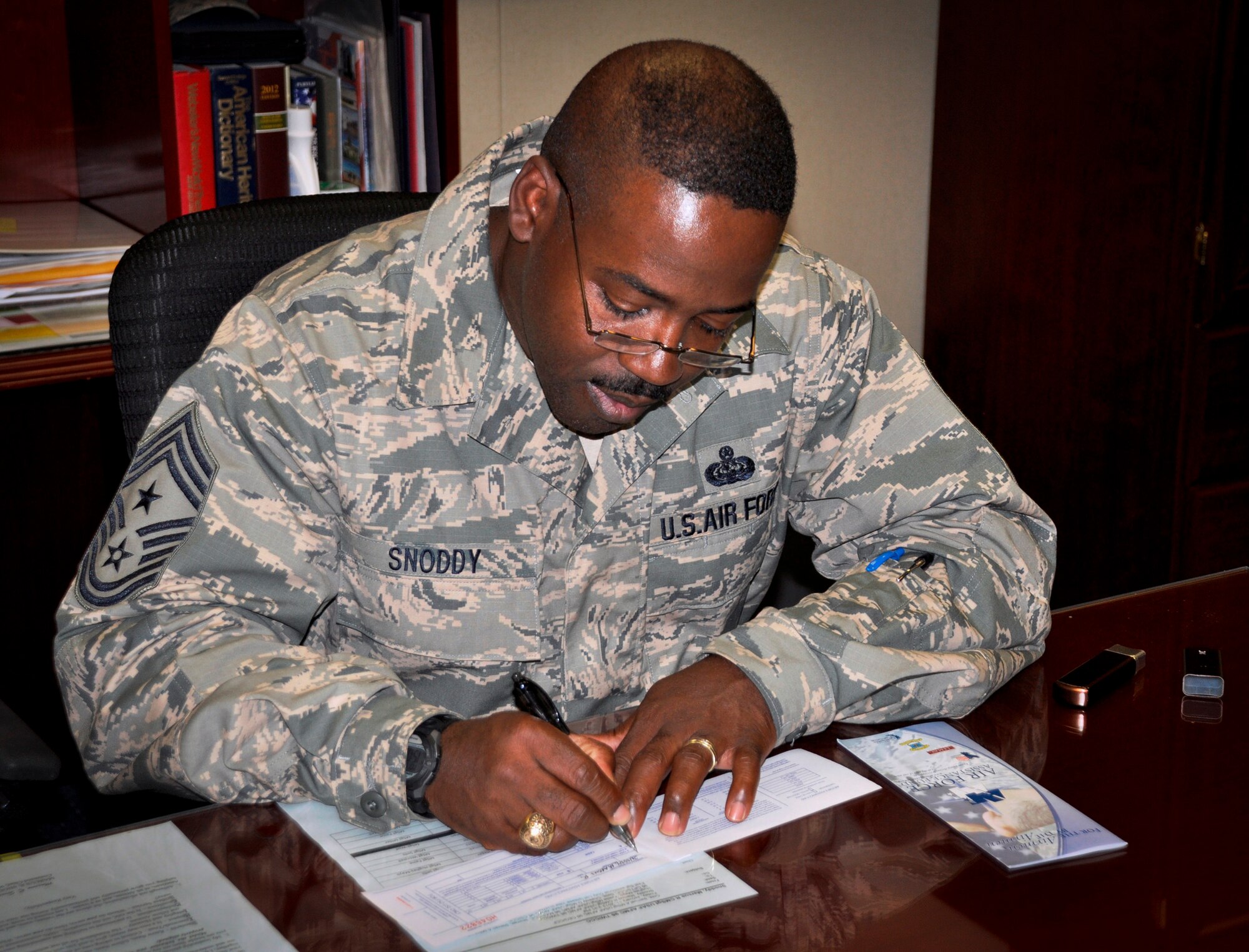 Chief Master Sgt. Marcus Snoddy, the 96th Test Wing command chief, completes the Air Force Assistance Fund forms at Eglin Air Force Base, Fla. The AFAF campaign supports four charities dedicated to caring for Airmen from induction through retirement and beyond. These charities include the Air Force Aid Society, General and Mrs. Curtis E. LeMay Foundation, the Air Force Village and the Air Force Enlisted Village. The deadline to donate for this year's campaign is May 3. The overall fundraising goal for Eglin is $118,000. To donate, contact your unit POC or the installation project officer, 1st Lt. Joseph Terndrup, at (850) 883-3227 or DSN 875-3227. (U.S. Air Force photo/Sara Vidoni)
