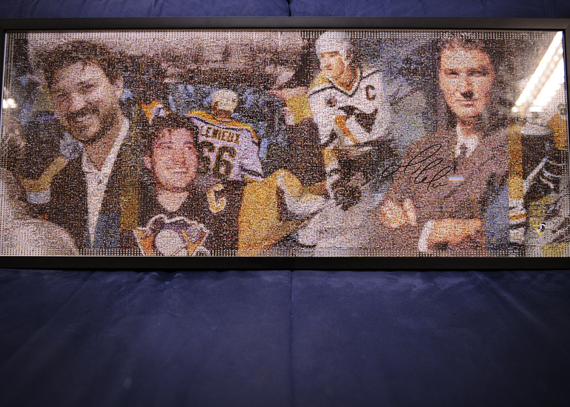 SPANGDAHLEM AIR BASE, Germany – A signed poster of Mario Lemieux sits on display April 10, 2013. Lemieux is famous for his time playing for the Pittsburgh Penguins from 1984 to 2006. He now co-owns the team. More than 100 other sports and entertainment items will be for sale during a silent auction 10 a.m. – 6 p.m., May 31 at the Brick House. All proceeds will fund Operation Warm Heart, a program designed to help out Airmen during times of financial crisis. (U.S. Air Force photo by Staff Sgt. Daryl Knee/Released)