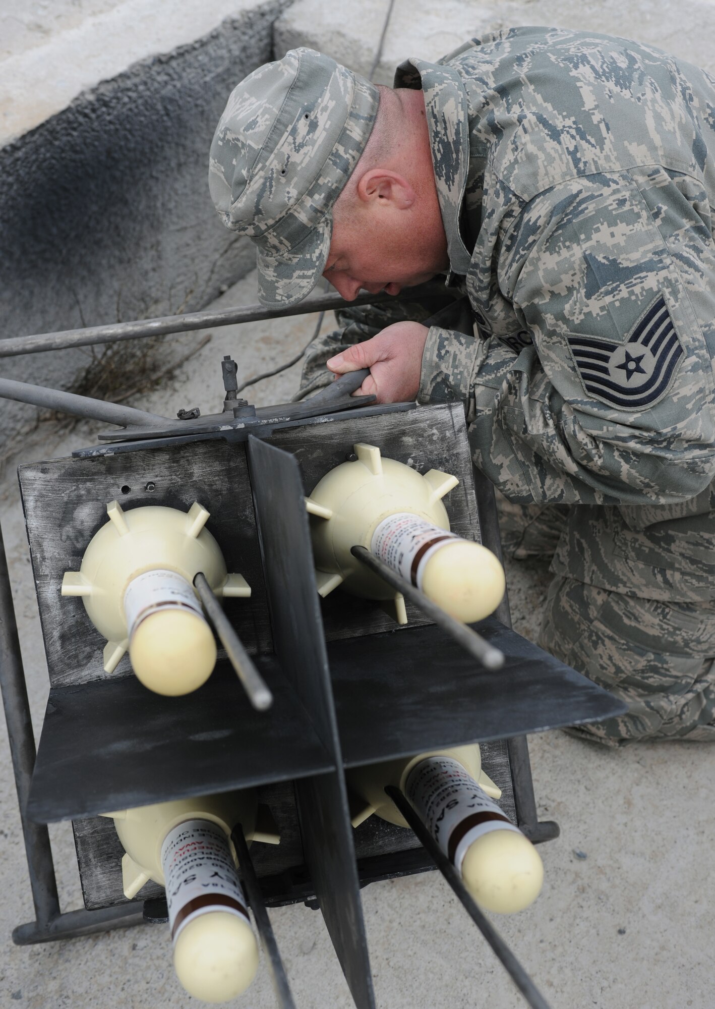 U.S. Air Force Tech Sgt. Ronald Warren, 266th Range Squadron ground radar systems craftsman, attaches the fuse cables to the bottom of a GTR-18 Smokey Sam training rocket mount April 3, 2013, at Mountain Home Air Force Base, Idaho. The 266th RANS use the Smokey Sams to assist aircrew with safe, realistic training. (U.S. Air Force photo by Senior Airman Benjamin Sutton/Released)