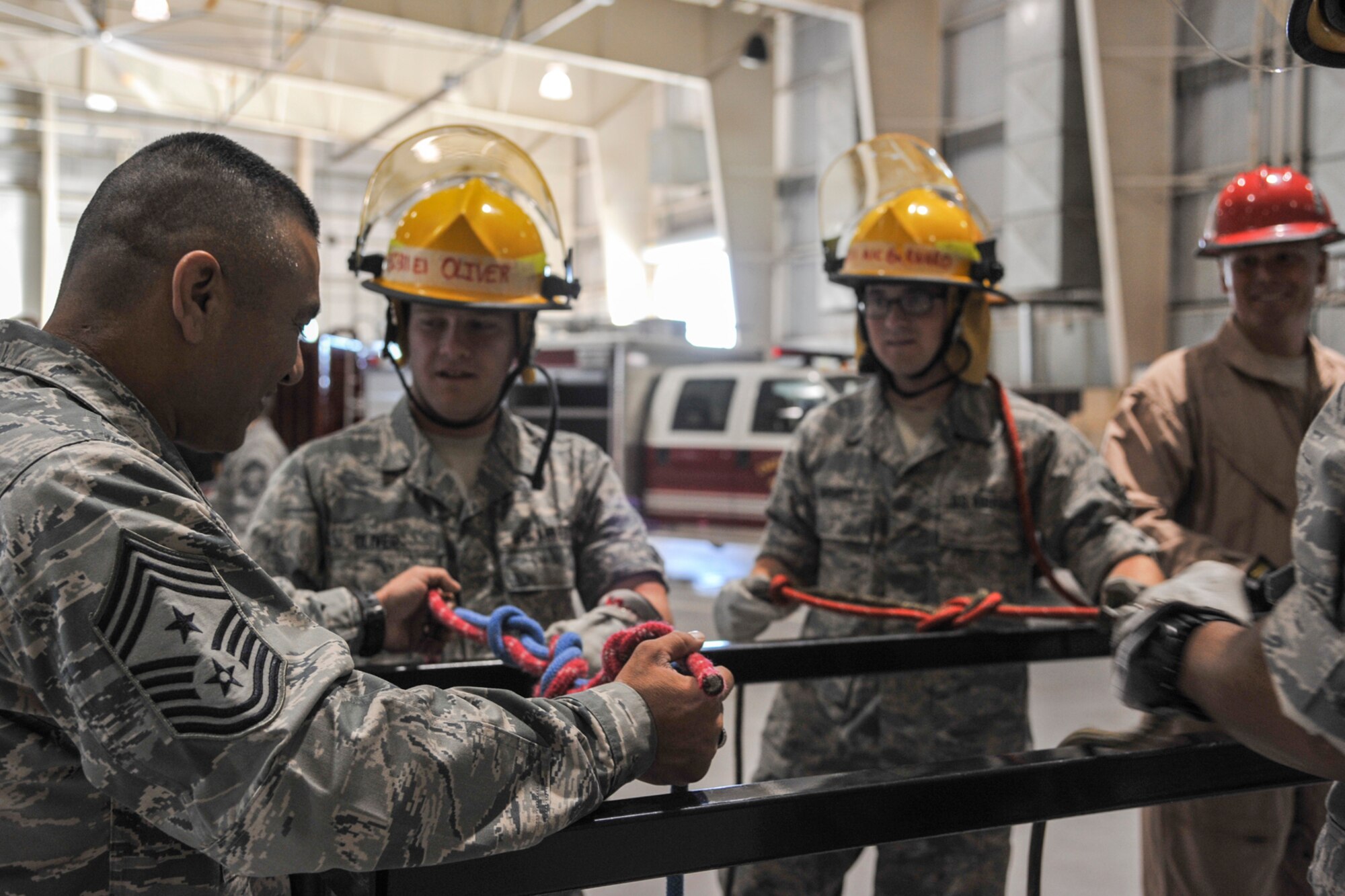 GOODFELLOW AIR FORCE BASE, Texas-- Chief Master Sgt. Gerardo Tapia, Command Chief of Air Education and Training Command, looks over a knot completed by 312th Training Squadron students at the Louis F. Garland Defense Department Fire Academy, here, April 11. Tapia visited to get a first-hand look at the firefighting and intelligence, surveillance and reconnaissance mission on Goodfellow. (U.S. Air Force photo/ Airman 1st Class Michael Smith)
