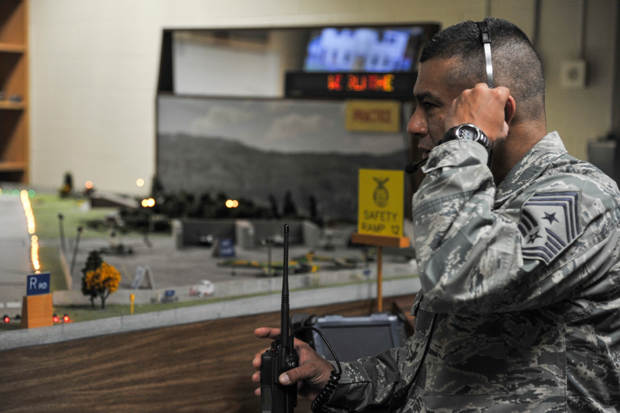 GOODFELLOW AIR FORCE BASE, Texas-- Chief Master Sgt. Gerardo Tapia, Command Chief of Air Education and Training Command, listens in on radio communications during a Norma Brown Trainer exercise at the Louis F. Garland Defense Department Fire Academy,here, April 11. Tapia witnessed first-hand the chaos that can be involved for a fire chief during an emergency. (U.S. Air Force photo/ Airman 1st Class Michael Smith)