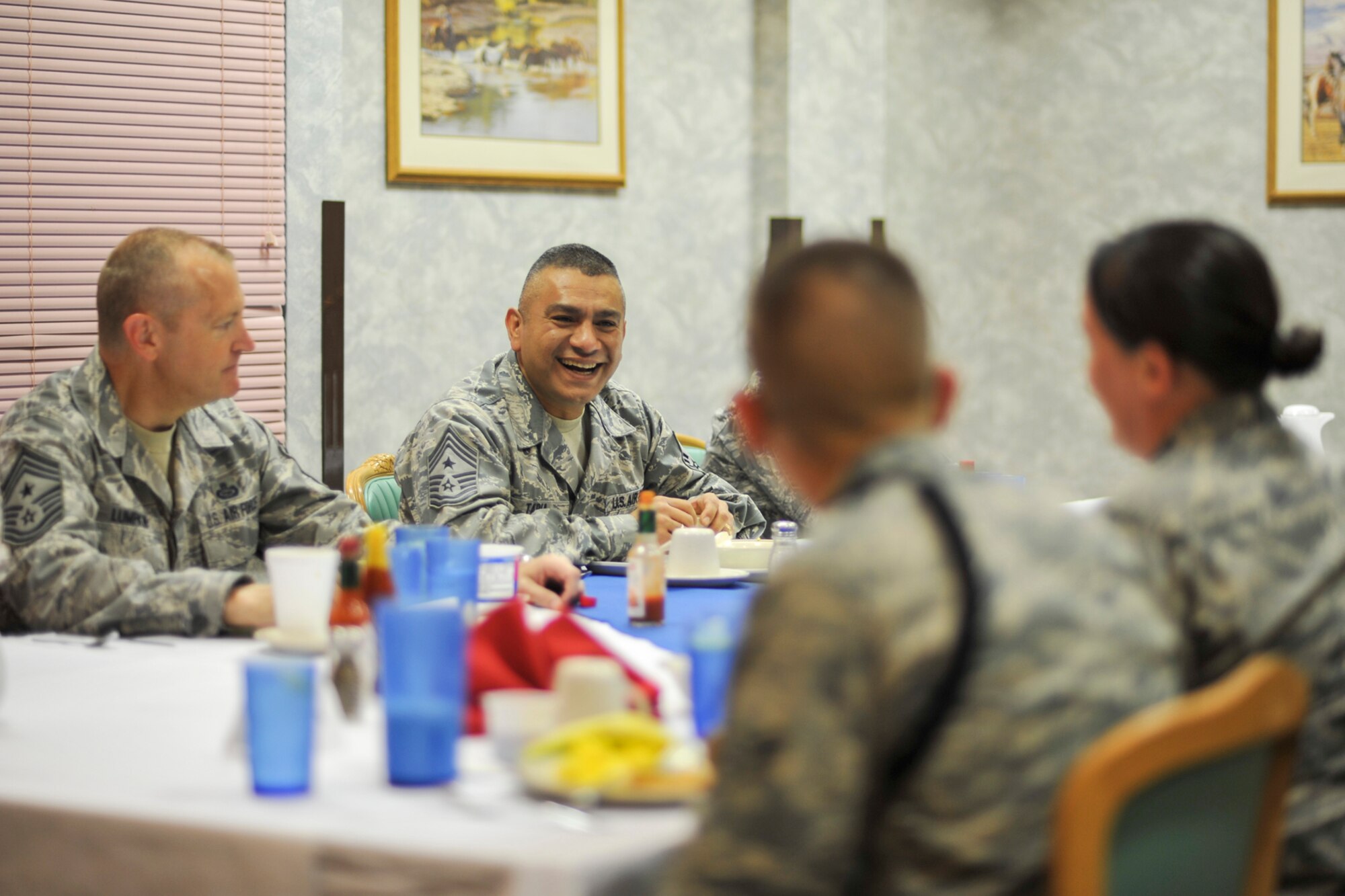 GOODFELLOW AIR FORCE BASE, Texas-- Chief Master Sgt. Gerardo Tapia, Command Chief of Air Education and Training Command, shares a laugh with 17th Training Group students at the Western Winds Dining Facility, here, April 11. Tapia ate lunch with the students and also gave them the opportunity to ask questions and voice concerns of training. (U.S. Air Force photo/ Airman 1st Class Michael Smith)