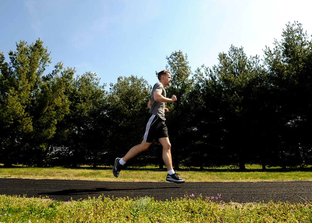 Staff Sgt. David Nicholson, 779th Aerospace Medical Squadron NCO in charge of presidential support, runs on an outdoor track April 10, 2013 at Joint Base Andrews, Md. Nicholson is preparing to particpate in the upcoming JBA Half Marathon by running during his lunch hour and on trails in Northern Virginia on the weekends. (U.S. Air Force photo/Staff Sgt. Brittany E.Jones)