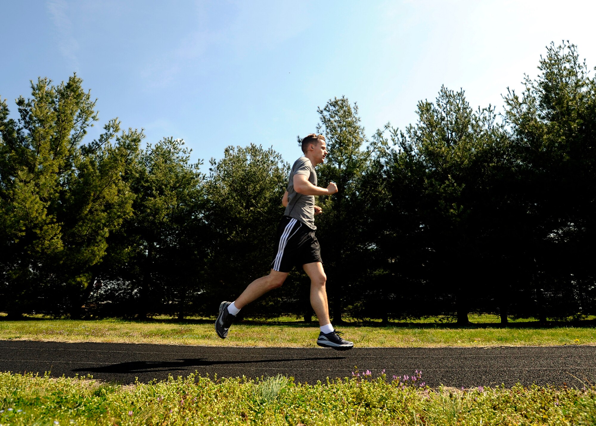 Staff Sgt. David Nicholson, 779th Aerospace Medical Squadron NCO in charge of presidential support, runs on an outdoor track April 10, 2013 at Joint Base Andrews, Md. Nicholson is preparing to particpate in the upcoming JBA Half Marathon by running during his lunch hour and on trails in Northern Virginia on the weekends. (U.S. Air Force photo/Staff Sgt. Brittany E.Jones)