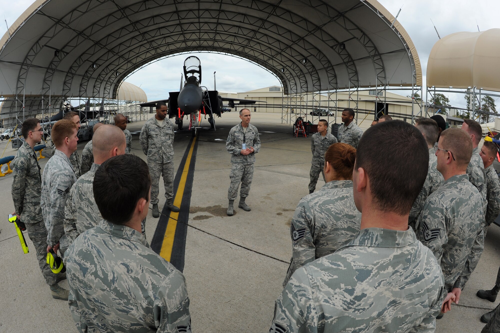 U.S. Air Force Chief Master Sgt. Peter Stone, 4th Fighter Wing command chief, speaks with Airmen from the 4th Aircraft Maintenance Squadron before the second half of a load crew competition on Seymour Johnson Air Force Base, N.C., April 5, 2013. Stone praised the Airmen for their professional appearance and presentation during an open-ranks inspection. (U.S. Air Force photo by Airman 1st Class John Nieves Camacho/Released)