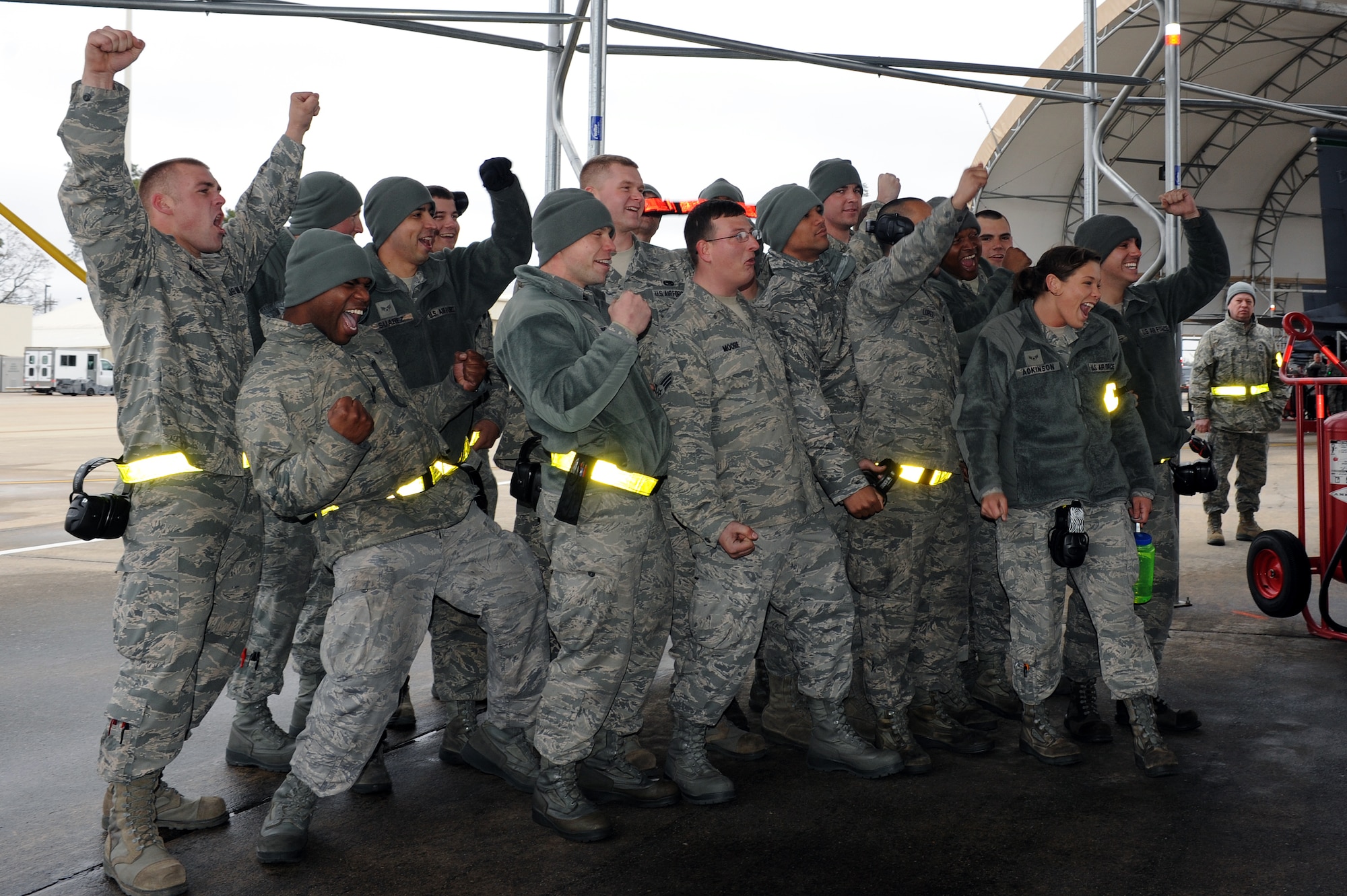 Airmen from the 4th Aircraft Maintenance Squadron cheer on their teammates from the 336th aircraft maintenance unit during a load crew competition on Seymour Johnson Air Force Base, N.C., April 5, 2013. The 336th AMU received the “Pride of the Fleet” award, symbolizing the most prideful unit. (U.S. Air Force photo by Airman 1st Class John Nieves Camacho/Released)