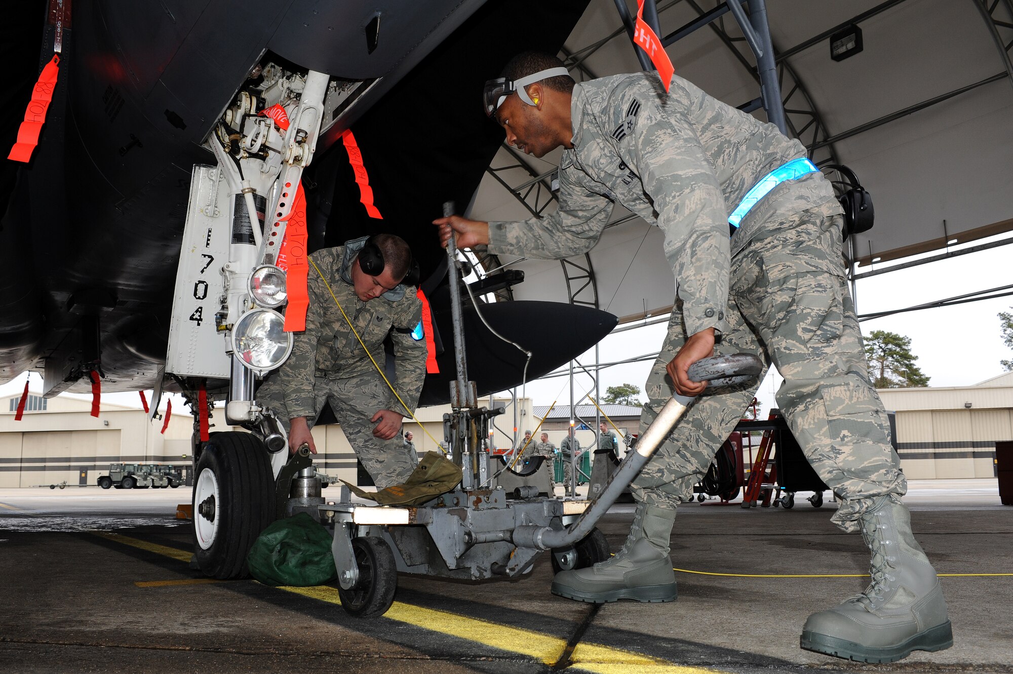 U.S. Air Force Senior Airman Justin Green and Staff Sgt. David Nichols, 4th Aircraft Maintenance Squadron crew chiefs, work together to remove a tire from an F-15E Strike Eagle during a load crew competition on Seymour Johnson Air Force Base, N.C., April 5, 2013. Crews were given a collapsed-nose gear inject and removed the tire in order to diagnose the problem. (U.S. Air Force photo by Airman 1st Class John Nieves Camacho/Released)
