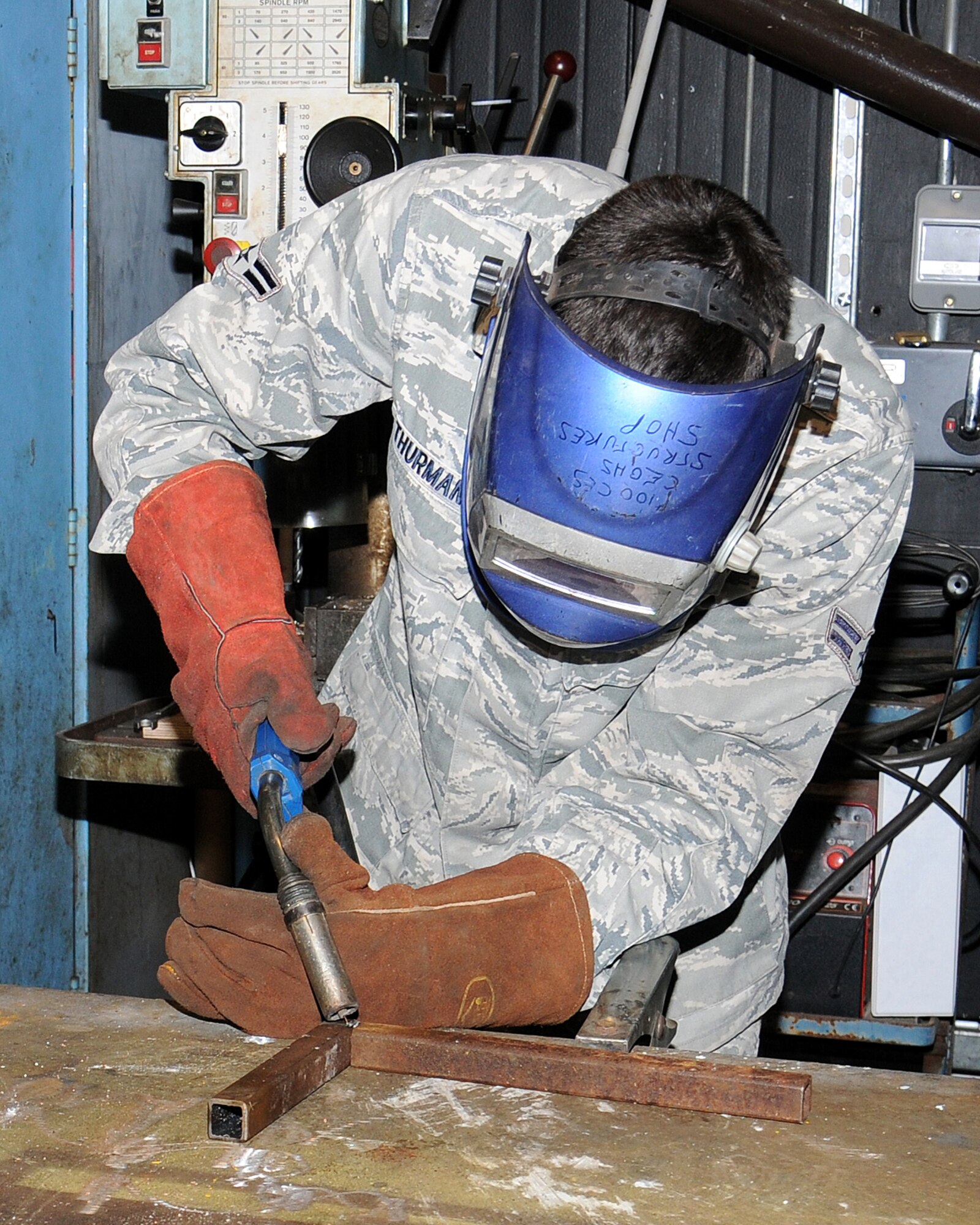 Airman 1st Class John Thurman, 100th Civil Engineer Squadron structural journeyman from Virginia Beach, Va., prepares to weld a piece of steel April 15, 2013, at RAF Mildenhall, England. The structures shop has many major areas of expertise including welding, carpentry, masonry and locksmiths. (U.S. Air Force photo by Gina Randall/Released)