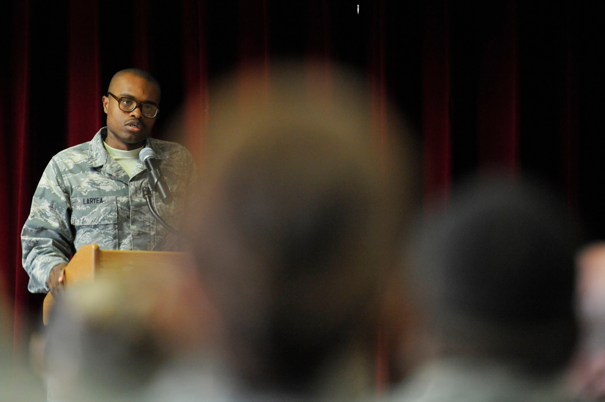 Airman 1st Class Lawrence Laryea, 86th Logistics Readiness Squadron material manager, reads a poem about the Holocaust during the Holocaust day of remembrance event at the Ramstein Community Center, April 12, 2013. The event is aimed at remembering and honoring all the victims of the Holocaust. (U.S. Air Force photo/Senior Airman Aaron-Forrest Wainwright)