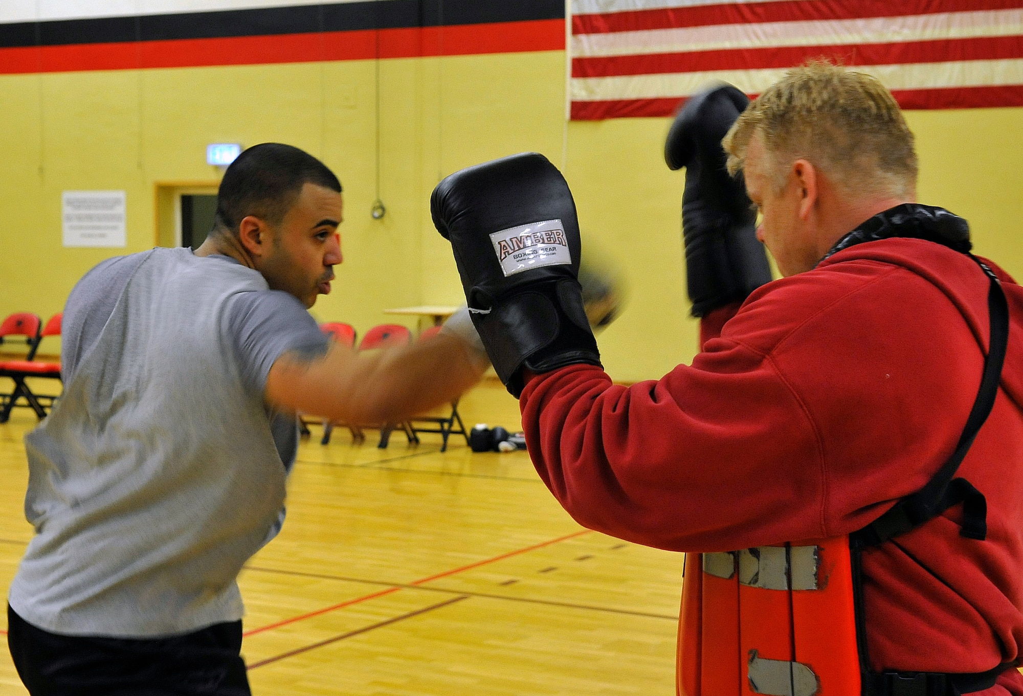 Staff Sgt. David Meredith, 721st Aerial Port Squadron security manager, spars against James Scullion, Celtic Warrior Boxing Club coach, during practice, Feb. 27, 2013, Miesau Army Depot, Germany. The combination of cardio, cross training and strength training makes boxing a great alternate workout for any fitness level. (U.S. Air Force photo/Airman 1st Class Trevor Rhynes)