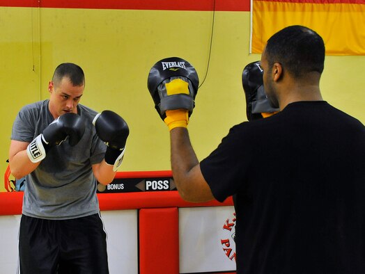 Staff Sgt. Stephen Basham, 693rd Intelligence Support Squadron plans and integrations, spars with Tech. Sgt. Thaddaus Zeno, 693rd Intelligence Support Squadron SIGNT systems NCOIC, Feb. 27, 2013, Miesau Army Depot, Germany. The combination of cardio, cross training and strength training makes boxing a great alternate workout for any fitness level. (U.S. Air Force photo/Airman 1st Class Trevor Rhynes)