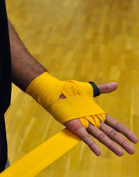 Tech. Sgt. Thaddaus Zeno, 693rd Intelligence Support Squadron SIGNT systems NCOIC wraps his hand prior to training, Feb. 27, 2013, Miesau Army Depot, Germany. Hand wraps are used in order to protect a fighter's hand. The combination of cardio, cross training and strength training makes boxing a great alternate workout for any fitness level. (U.S. Air Force photo/Airman 1st Class Trevor Rhynes)