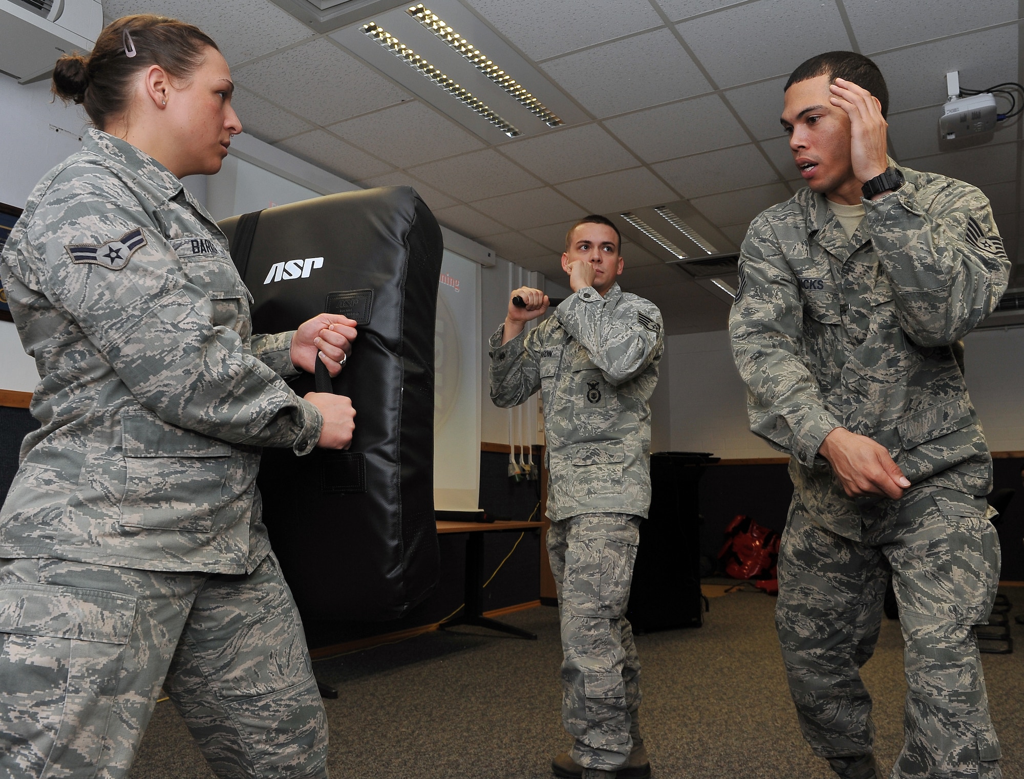 Tech. Sgt. Christopher Ricks, (right) 86th Security Forces Squadron instructor, teaches proper technique when utilizing the ASP baton to Airman, April 11, 2013, Ramstein Air Base, Germany. 86th SFS and the 569th U.S. Forces Police Squadron came together to train Airmen in verbal judo and certify them on non-lethal weapon training and combatives. (U.S. Air Force photo/Airman 1st Class Dymekre Allen)     