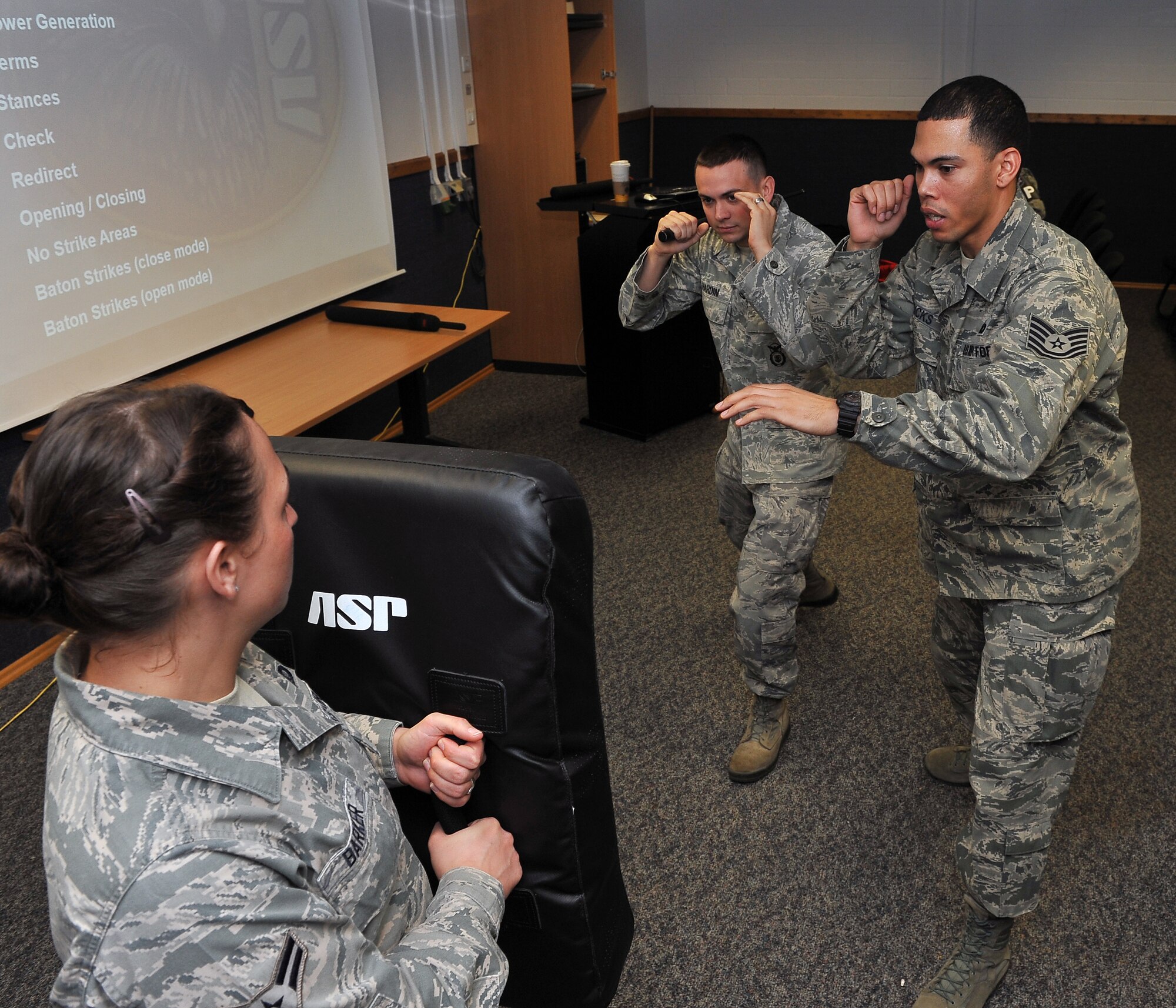 Tech. Sgt. Christopher Ricks, (right) 86th Security Forces Squadron instructor, teaches proper technique when utilizing the ASP baton to Airman, April 11, 2013, Ramstein Air Base, Germany. 86th SFS and the 569th U.S. Forces Police Squadron came together to train Airmen in verbal judo and certify them on non-lethal weapon and combatives. (U.S. Air Force photo/Airman 1st Class Dymekre Allen)   