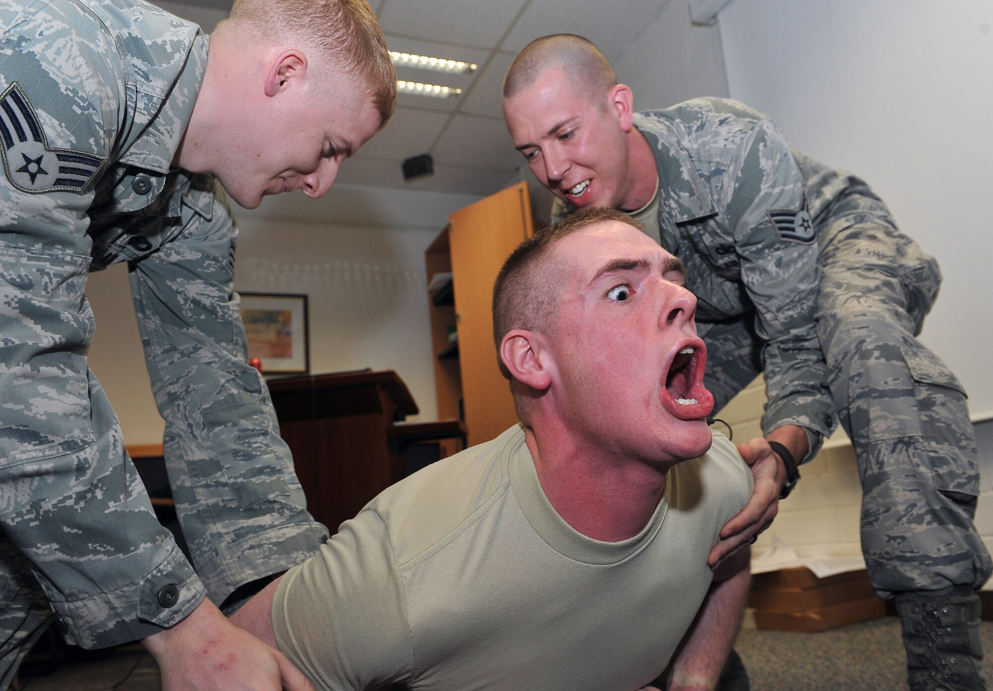 Airman 1st Class Steven Mills, 86th Security Forces Squadron patrolman, reacts to being tased, April 11, 2013, Ramstein Air Base, Germany. 86th SFS and the 569th U.S. Forces Police Squadron came together to train Airmen in verbal judo and certify them on non-lethal weapons and combatives. (U.S. Air Force photo/Airman 1st Class Dymekre Allen)     