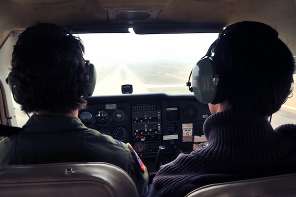 Capt. Mari Metzler, left, 51st Medical Group aerospace and operational physiologist flight commander, demonstrates landing a 1983 Cessna 172, while Yon San Yun, 51st Force Support Squadron Flight Training Center instructor pilot, grades her performance on the flightline at Osan Air Base, Republic of Korea, April 8, 2013. During her practice flight, Metzler performed three different landings. (U.S. Air Force photo/Senior Airman Alexis Siekert)