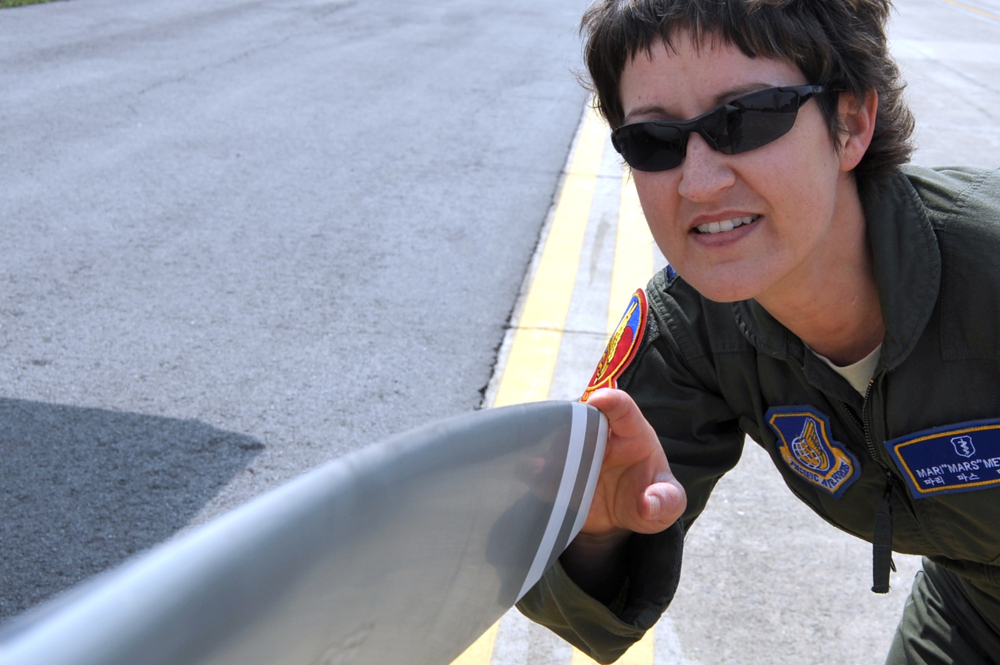 Capt. Mari Metzler, 51st Medical Group aerospace and operational physiologist flight commander, 	inspects the propeller of a 1983 Cessna 172 before flight at the Osan Flight Training Center on Osan Air Base, Republic of Korea, April 8, 2013. Pilots must complete multiple pre-flight checklists to ensure aircraft are ready for flight before takeoff. (U.S. Air Force photo/Senior Airman Alexis Siekert)