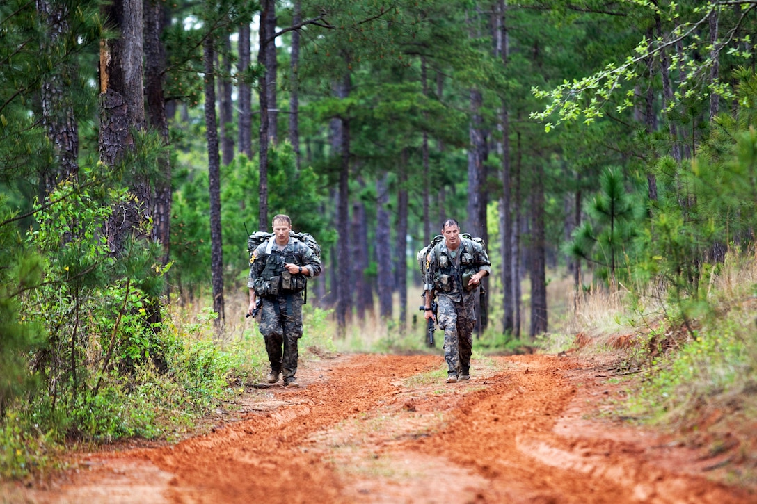 Army Sgts. 1st Class John M. Gendron and Joshua Horsager finish the first foot march of the 30th annual Best Ranger Competition on Fort Benning, Ga., April 12, 2013. Gendron and Horsager are assigned to the 75th Ranger Regiment. The foot march exceeded 15 miles.