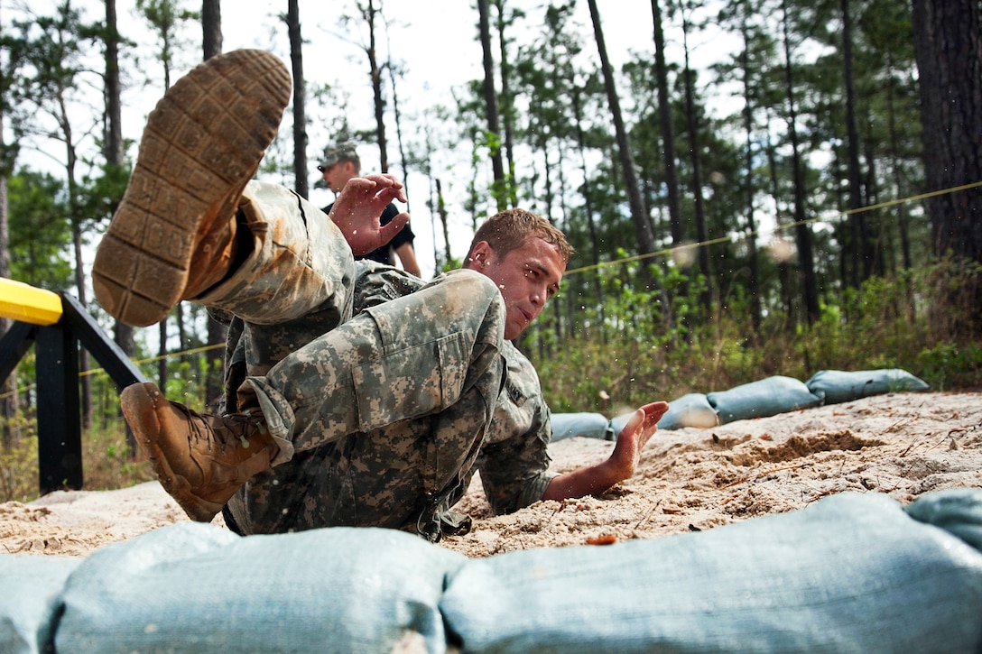 Army Staff Sgt. Christopher Brousard completes the combat roll obstacle  during the 30th annual Best Ranger Competition on Fort Benning, Ga., April 12, 2013. Brousard is assigned to the 75th Ranger Regiment.