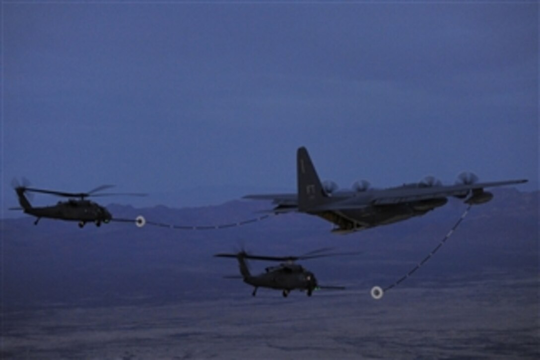 A U.S. Air Force HC-130J Combat King II aircraft conducts aerial refueling with two HH-60G Pave Hawk helicopters during exercise Angel Thunder 2013 near Davis-Monthan Air Force Base, Ariz., on April 11, 2013.  Angel Thunder is a combat search and rescue exercise designed to provide training for recovery personnel in a variety of scenarios to simulate deployment conditions and contingencies.  The Combat King is assigned to the 79th Rescue Squadron and the Pave Hawks are assigned to the New York Air National Guard.  