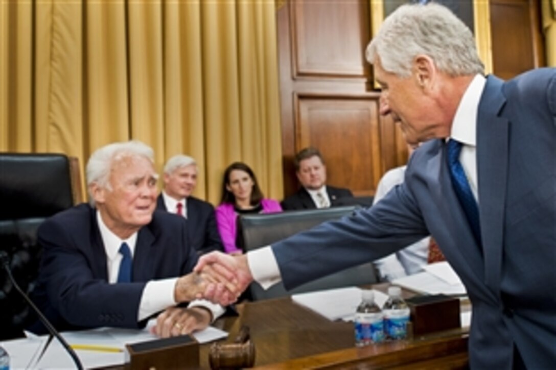 Defense Secretary Chuck Hagel greets U.S. Rep. C.W. Bill Young of Florida, chairman of the House Appropriations Committee's defense subcommittee in Washington, D.C., April 16, 2013. Hagel testified on the 2014 defense budget request.