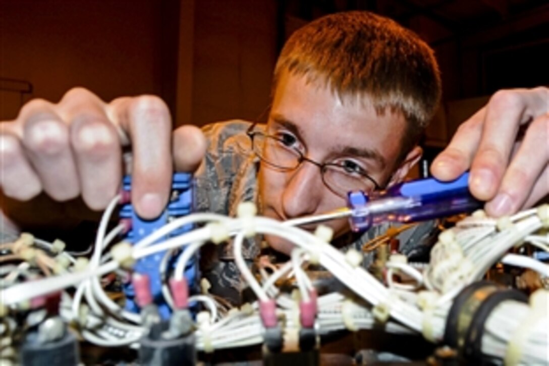 U.S. Air Force Airman 1st Class Ross Honomichl checks a generator for faulty wires at the power production warehouse at Altus Air Force Base, Okla., April 12, 2013. Honomichi is a power production journeyman assigned to the 97th Civil Engineer Squadron.