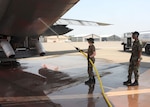 Senior Master Sgt. Aaron "Stoney" Smith, assigned to the 153rd Airlift Wing of the Wyoming Air National Guard, watches for safety issues as an Airman washes fire retardant off the cargo doors of a C-130 Hercules equipped with the modular airborne fire fighting system at McClellan Airfield July 8. Smith's job is to ensure Airmen and equipment are safe during the high tempo of fire fighting operations. The 153rd AW is conducting firefighting operations as part of the 302nd Air Expeditionary Group. The 302nd AEG, comprised of aircraft from the Air Force Reserve, Air National Guard, Navy Reserve and Marine Corps, provides unique capabilities and is part of a unified military support effort of U.S. Northern Command to provide assistance to the U.S. Forest Service, the California Department of Forestry and Fire Protection, and the National Interagency Fire Center. USNORTHCOM continues to closely monitor the California wildfires to anticipate additional requests for Department of Defense assistance to local, federal, and state civil authorities.