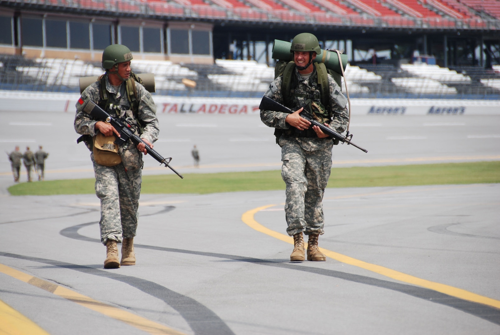 Eldwood Kaumeheiwa (left) from Georgia and Jason Garcia (right)from Alabama head for the finish line at Talladega Super Speedway. Kaumeheiwa and Garcia are among 173 officer candidates at the Alabama Military Academy's Officer Candidate School who completed a 7 mile road march that ended by completing one lap around the Speedway. One lap at the Speedway is approximately 2.6 miles. 