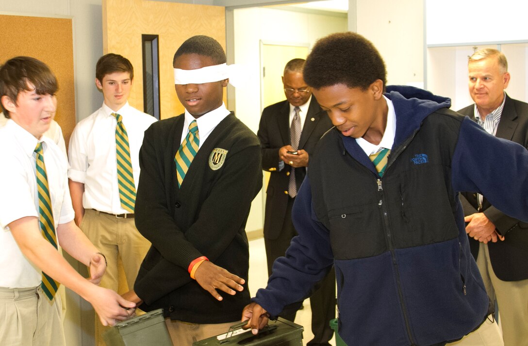 Students pass ammo cans to one another during a Marine Corps Leadership Seminar aboard Wake County Young Men’s Leadership Academy in Raleigh, N.C., April 11. The Marine Corps Leadership Seminar has been hosted by colleges and universities across the country for the past three years; however, this is the first time the event has been hosted at a high school.