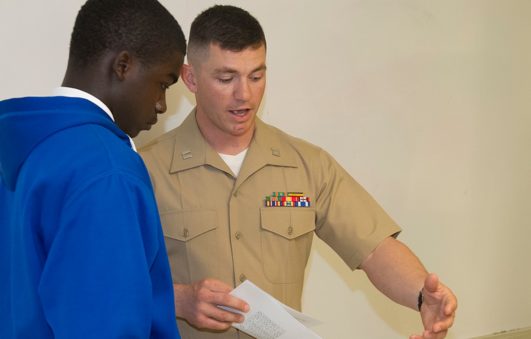 Capt. Michael R. Schulz, an instructor with Officer Candidates School in Marine Corps Base Quantico, Va., explains a task to a student during a Marine Corps Leadership Seminar aboard Wake County Young Men’s Leadership Academy in Raleigh, N.C., April 11. The Marine Corps Leadership Seminar has been hosted by colleges and universities across the country for the past three years; however, this is the first time the event has been hosted at a high school.