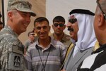 76th Infantry Brigade Combat Team Deputy Commander Col. Kenneth Newlin greets local leader Sheikh Saad Hasan Altememy during a ribbon-cutting ceremony for an Iraqi-run recycling center Thursday, July 11, 2008, at Joint Base Balad, Iraq. The 76th IBCT, along with many other sheikhs from the surrounding Balad area, are currently working together through the Iraqi-Based Industrial Zone program. The initiative compliments the Multi-National Forces-Iraq's mission by providing safe, secure jobs for local Iraqis and by giving them additional contracting opportunities normally reserved for larger, foreign corporations.