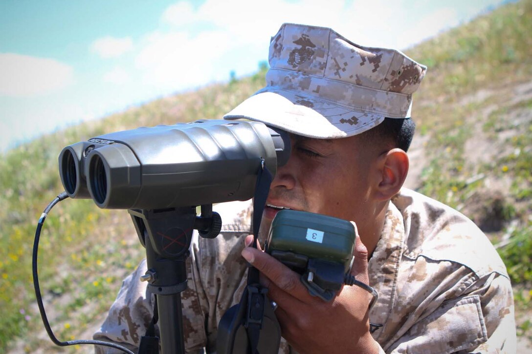 Lance Cpl. Luis Herrera, a forward observer serving with 2nd Battalion, 11th Marine Regiment, observes the impact area during a fire mission here, April 3, 2013. Herrera, a 23-year-old-native of Chino, Calif., and his fellow forward observers are training to deploy with the 31st Marine Expeditionary Unit.