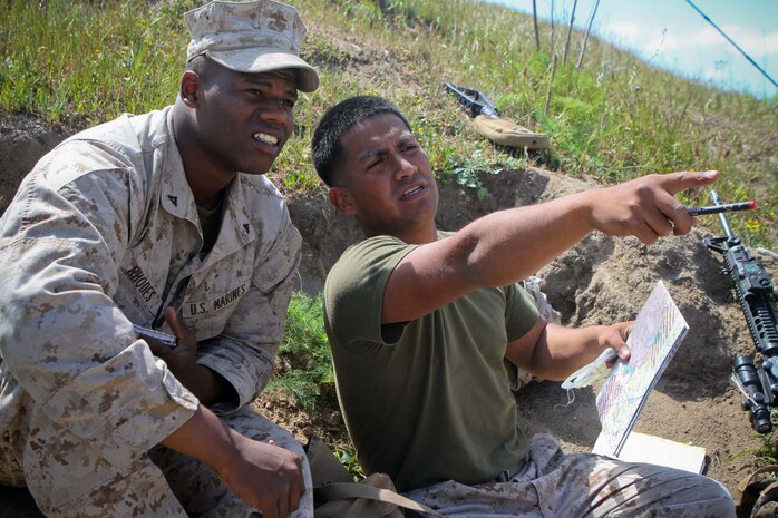 Lance Cpl. Luis Herrera and Lance Cpl. Kevin Rhodes, forward observers serving with 2nd Battalion, 11th Marine Regiment, observe key features in the terrain before conducting a training and readiness examination during a live-fire exercise here, April 3, 2013. Rhodes, a 20-year-old native of Quincy, Mass., and Herrera, a 23-year-old-native of Chino, Calif., are training to deploy with the 31st Marine Expeditionary Unit.