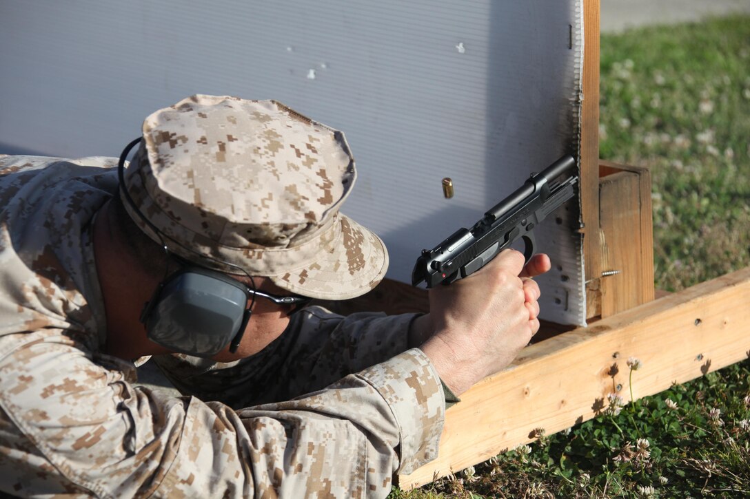A 9mm casing is ejected out of a M9 Berretta while Master Sgt. Raymundo Muro, operations chief with the Provost Marshall Office, fires a round down range during a PMO pistol shoot at the station range April 11. 