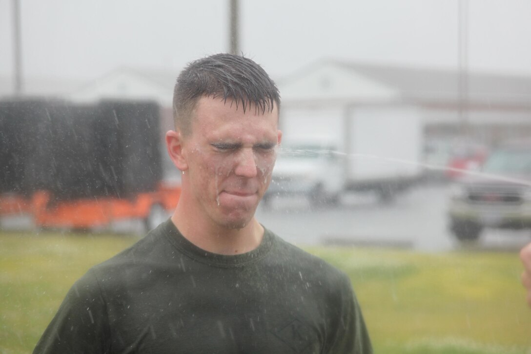Lance Cpl. James R. Skelton III, a military police officer with the Provost Marshall Office, is sprayed with OC Spray during a PMO OC Spray at PMO April 12.  OC Spray is a highly concentrated pepper, hence the name pepper spray, said Cliff Croom, a training specialist with homeland security solutions Inc. 