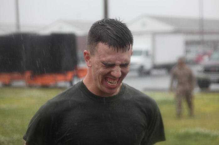 Lance Cpl. James R. Skelton III, a military police officer with the Provost Marshal’s Office, fights to open his eyes after being sprayed with oleoresin capsicum during training here April 12.  Military policemen have to qualify with the spray to be eligible to carry it on duty.