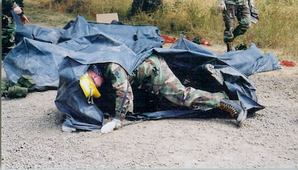 An Oregon National Guard member wrestles with his shelter during fire training before the 2007 fire season. Oregon Gov. Ted Kulongoski has announced plans to activate more than 300 Guard members to attend Firefighter II certification training at three sites in Oregon.