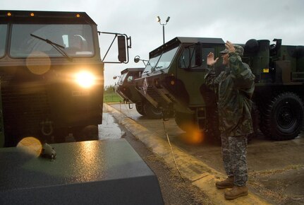 Army Sergeant 1st Class Jeff Printy marshals in nine light-medium tactical vehicles deployed from San Antonio to the Standing Joint InterAgency Task Force headquarters located at the Army National Guard Armory July 22 in Weslaco, Texas. Texas lilitary forces came to southern Texas in anticipation of heavy flood relief efforts caused by Hurricane Dolly.