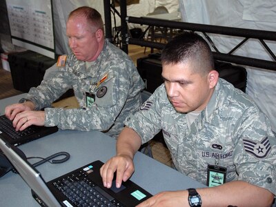 Sgt. Marc Jones (left) of the Texas Army National Guard's Standing Joint Interagency Task Force (SJIATF) and Staff Sgt. Gonzalo Roman of Texas Air National Guard 149th Fighter Wing at San Antonio Emergency Operation Center as Hurricane Dolly moves westward towards south Texas Aug. 23. The Category 2 hurricane that is the first of the 2008 Atlantic Hurricane season severely damaged the coastal cities Brownsville and South Padre Island with strong winds and heavy flooding.