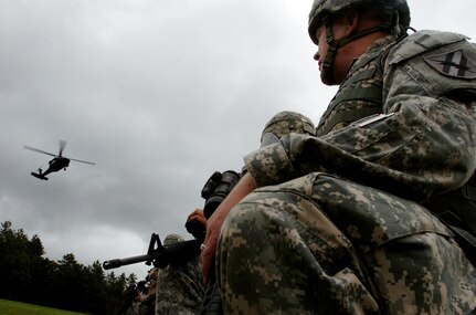 Soldiers from Company A, 48th Brigade Special Troops Battalion wait to board a landing UH-60 Black hawk helicopter during exercise Patriot '08 at FOrt McCoy, Wisc., Sunday, July 20, 2008. The company recently transitioned from being a heavy engineer to unit based on M113 Armored Personnel Carriers to a light unit that utilizes helicopters and humvees and the Soldeirs were using the exercise as a way to hone their skills working with new tactics. Patriot '08 was a large-scale training exercise that brought together elements from the U.S. Army and Air Force as well as units from the British, Dutch and Canadian armies.