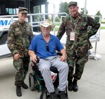 Air Force Airman 1st Class Vicki Pelan, left, and Senior Master Sgt. Steve Goodner, both members of the Nebraska Air National Guard's 155th Air Refueling Wing, chat with Army veteran Wayne Muscato during the National Disabled Veterans Wheelchair Games.