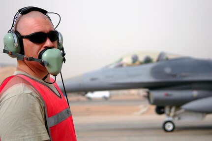 Tech Sgt. Jason Owens talks to fighter pilots during arming of an F-16 Fighting Falcon here July 8. When the Syracuse, N.Y., Air National Guard unit returns from its current deployment to Joint Base Balad, it will become the first Air National Guard unit in the country to adopt an MQ-9 Reaper unmanned aerial system mission. Sergeant Owens, a weapons specialist with the 332nd Expeditionary Fighter Squadron, is deployed from Hancock Field Air National Guard Base in Syracuse, N.Y.