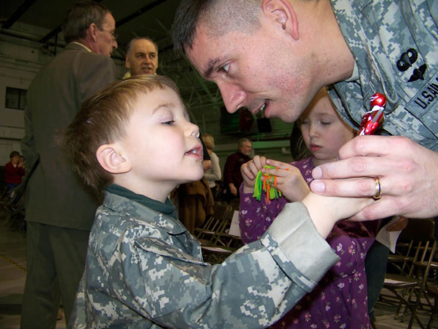 Maj. Scott Jessop of New York Army National Guard's 27th Infantry Brigade Combat Team, shares a moment with his son Ben Jessop and daughter Carrie Jessop during a Send-Off Ceremony before deploying to Afghanistan to train the Afghan National Army and Police Force. When he returns, new programs will screen him for PTSD, TBI and help them re-integrate.