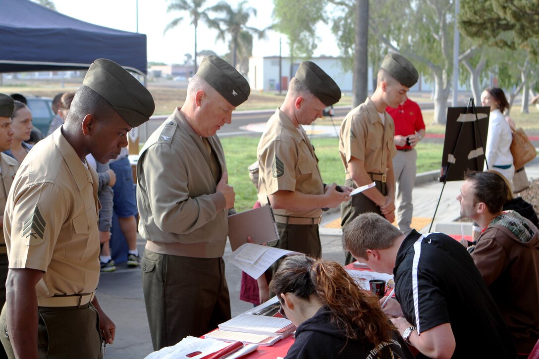 Marines check in with Erika Armenta and Matt Joseph, San Diego State University student veterans and Los Angeles and Perrysburg, Ohio natives respectively, prior to the Basic Training for Higher Education Conference aboard Marine Corps Air Station Miramar, Calif., April 12. Service members of all ranks, veterans and family members were welcomed by a continental breakfast and various representatives from local colleges.