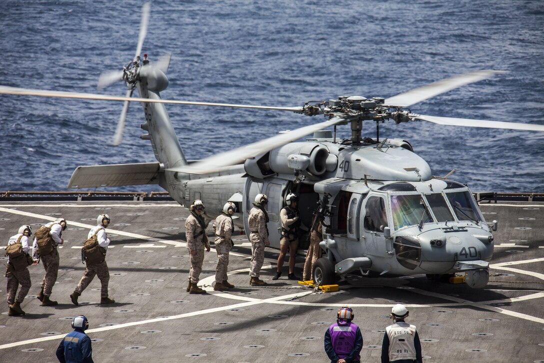 Capt. Raymond Kaster, 1st Lt. Jonathan Riebe, and 2nd Lt. Michael Swenson board a U.S. Navy MH-60S Seahawk aboard the USS Carter Hall (LSD 50) while at sea April 13, 2013. The MEU is currently deployed as part of the Kearsarge Amphibious Ready Group to the 5th Fleet area of operation. The 26th MEU operates continuously across the globe, providing the president and unified combatant commanders with a forward-deployed, sea-based quick reaction force. The MEU is a Marine Air-Ground Task Force capable of conducting amphibious operations, crisis response and limited contingency operations.
(U.S. Marine Corps photo by Staff Sgt. Edward Guevara/Released)