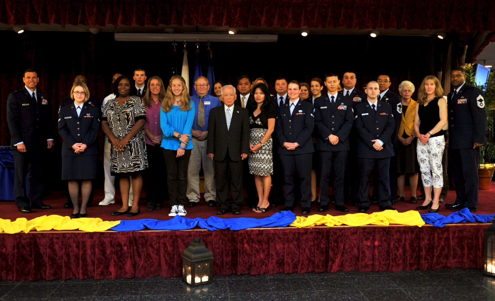 Members from the Kadena Air Base volunteer resource program take a group photo during the volunteer recognition ceremony in the Rocker NCO Club ballroom on Kadena Air Base, Japan, April 15, 2013. The volunteers were recognized by U.S. Air Force Brig. Gen. Matt Molloy, 18th Wing commander, for dedicating 512,519 volunteer hours in 2012. (U.S. Air Force photo by Naoto Anazawa/Released)