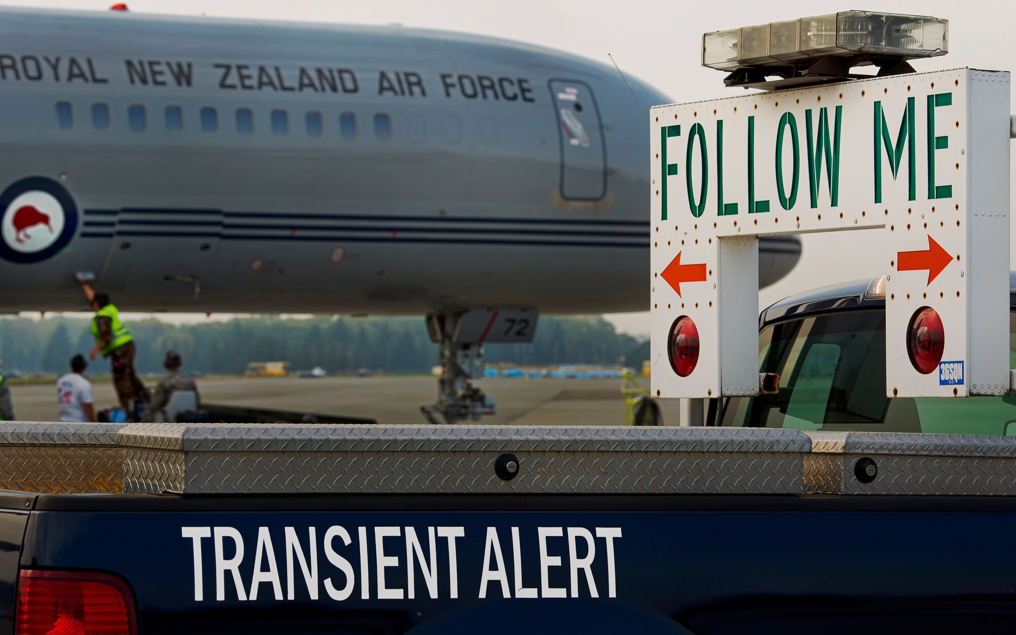 YOKOTA AIR BASE, Japan -- A "Follow-Me" vehicle from the 374th Maintenance Squadron Transient Alert shop stands by to provide servicing and maintenance support to a Royal New Zealand Air Force Boeing 757 aircraft at Yokota Air Base, Japan, April 17, 2013. (U.S. Air Force photo by Osakabe Yasuo)