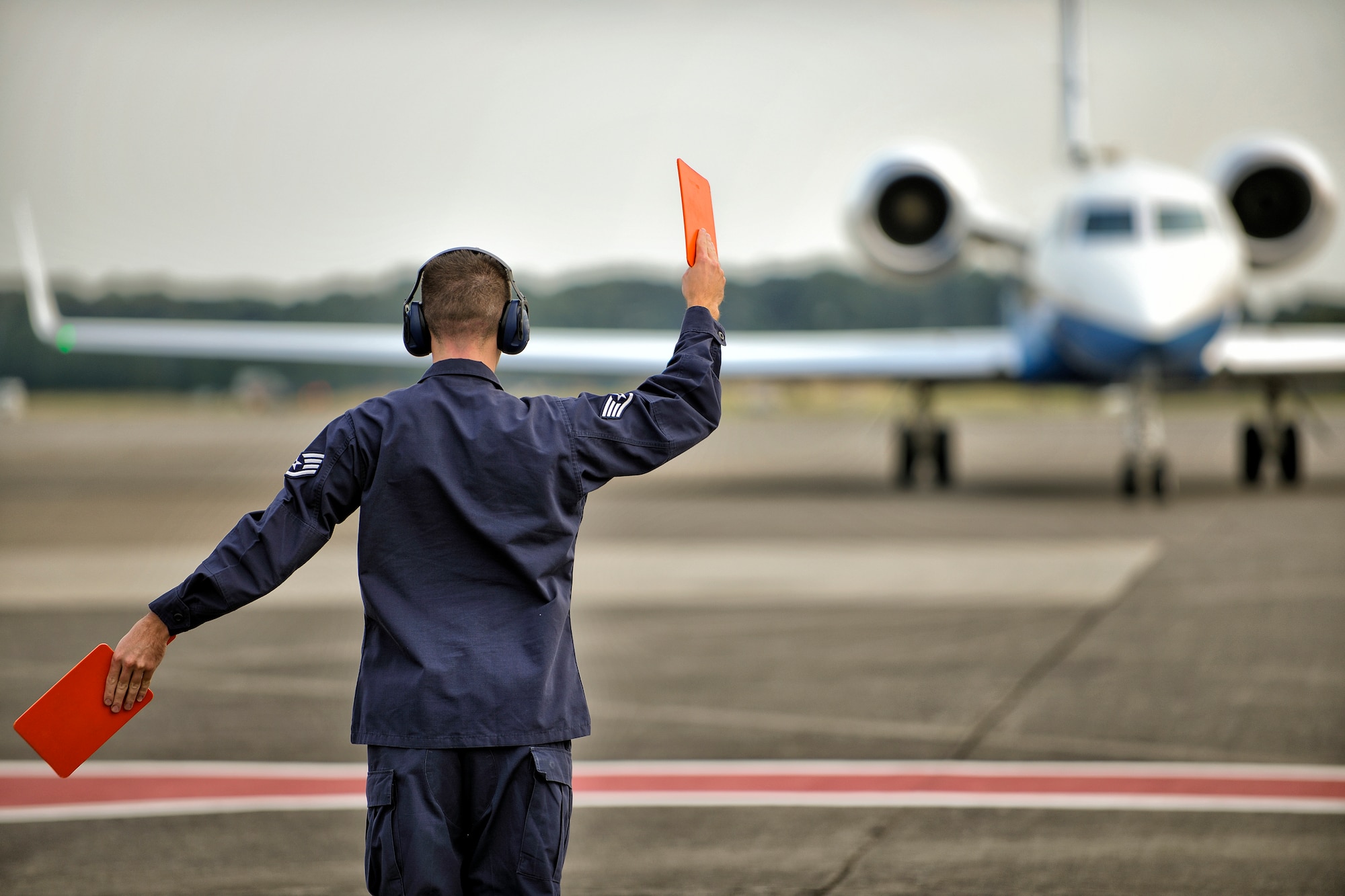 YOKOTA AIR BASE, Japan -- An Airman from 374th Maintenance Squadron Transient Alert marshals a C-37 aircraft at Yokota Air Base, Japan, Sept. 23, 2009. (U.S. Air Force photo by Osakabe Yasuo)